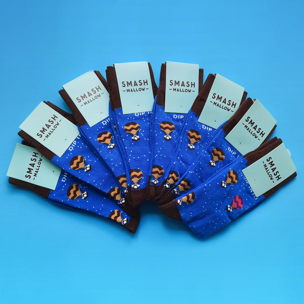 A pile of custom knitted socks in a range of brand colours and woven designs