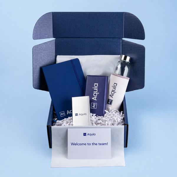 Gift box with Aquia branded items on a light blue background