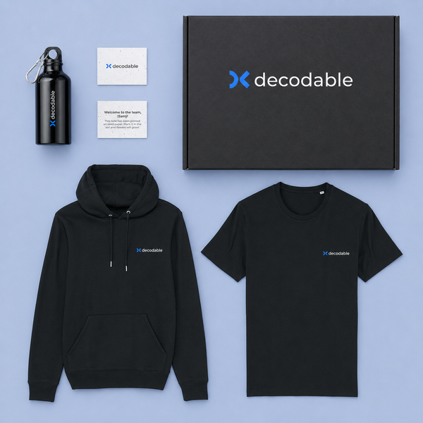 Black hoodie, t-shirt, water bottle, and cards with decodable logo on a blue background