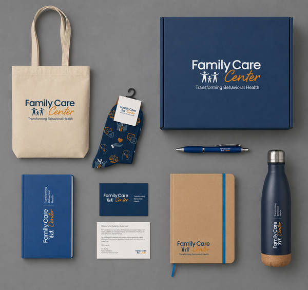 Collection of branded promotional items including a tote bag, box, pen, notebook, water bottle, and cards with 'Family Care Center' logo on a gray background.