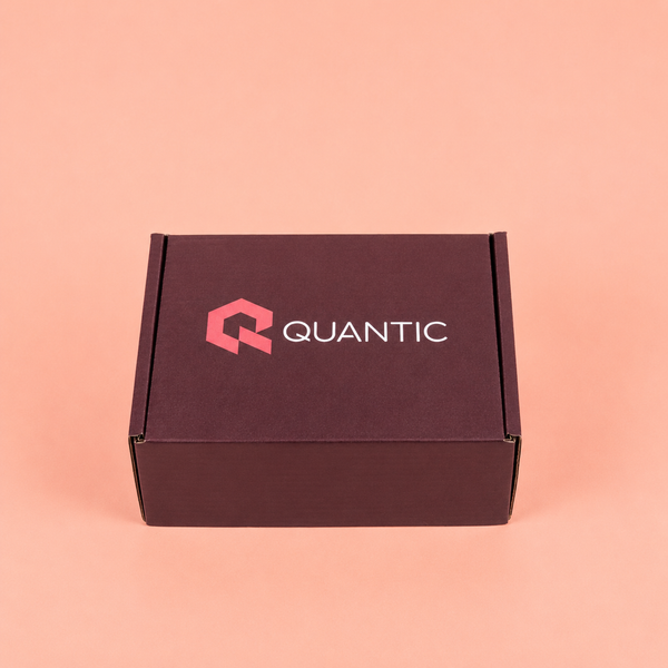 Brown box with 'Quantic' logo on a pink background