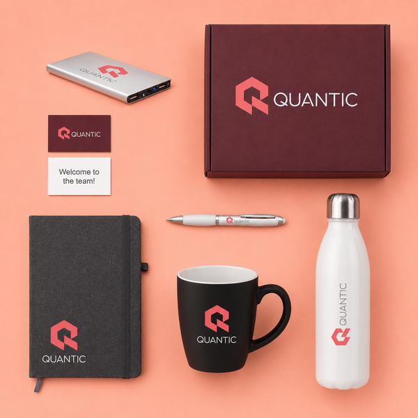 Collection of Quantic branded items including a box, mug, notebook, water bottle, and pen on a peach background.
