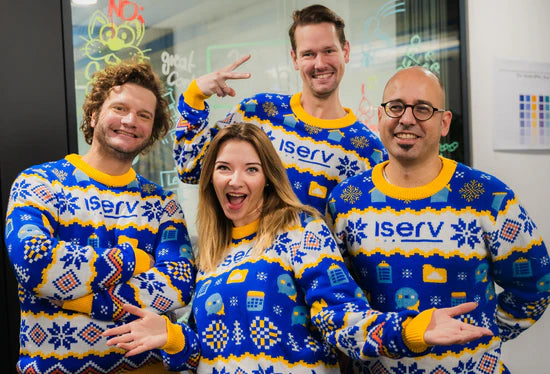 The IServ team wearing their custom knitted Christmas sweaters